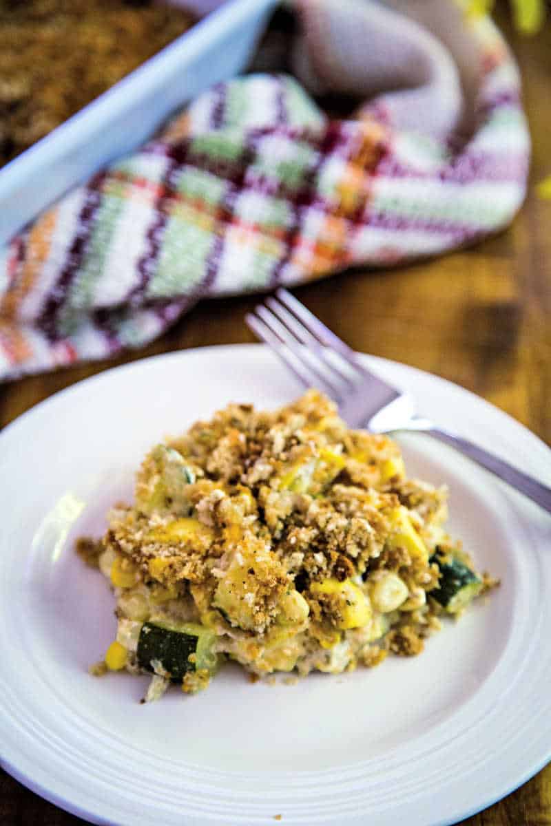 a serving of squash and zucchini casserole on a white plate