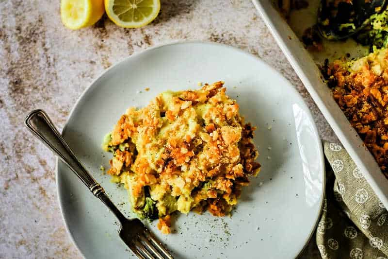 a serving of chicken curry broccoli casserole on a white plate with a fork