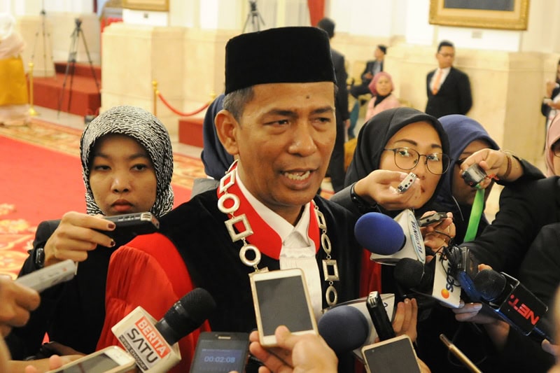 Hakim Mahkamah Konstitusi, Saldi Isra, menjawab pertanyaan wartawan usai pelantikan di Istana Negara, Jakarta, Selasa (11/4). (Foto: Humas/Deni).