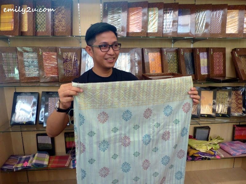 a visitor, Nuar Md Diah, checking out songket