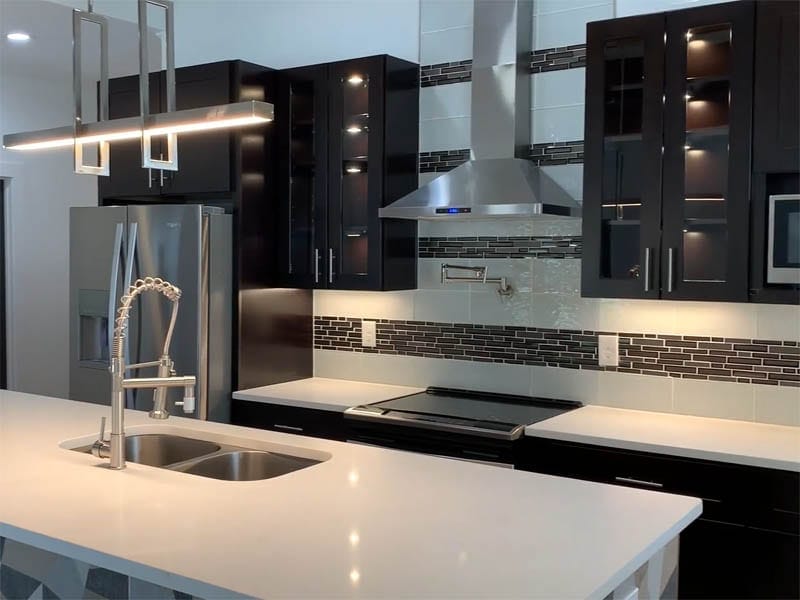 New kitchen construction close up of kitchen island and countertop space with cabinets and stove hood