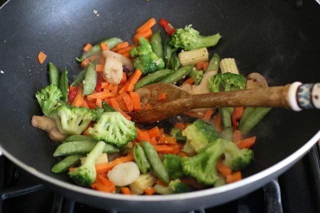 frozen vegetables added to wok