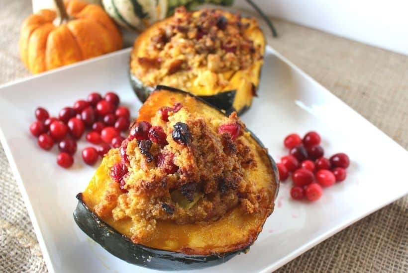Roasted Acorn Squash with Cornbread Sausage Stuffing is a perfect recipe for Thanksgiving and fall. Fresh cranberries, cornbread and sausage round out this easy acorn squash recipe. This sausage stuffed acorn squash makes an easy fall main dish or delicious holiday side. Also, you'll learn how to cook acorn squash. Try this baked acorn squash recipe for dinner.
