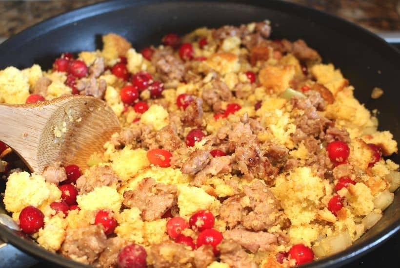Roasted Acorn Squash with Cornbread Sausage Stuffing is a perfect recipe for Thanksgiving and fall. Fresh cranberries, cornbread and sausage round out this easy acorn squash recipe. This sausage stuffed acorn squash makes an easy fall main dish or delicious holiday side. Also, you'll learn how to cook acorn squash. Try this baked acorn squash recipe for dinner.