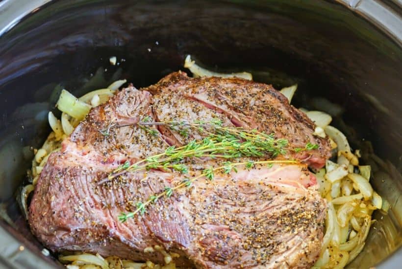 These flavorful Easy Crock Pot French Dip Sandwiches are a family favorite. Top them with provolone cheese and serve with a side of au jus. This Slow Cooker French Dip Sandwich recipe is perfect for a weeknight meal or to serve at a game day party or casual get together. This is an easy sandwich recipe that everyone will enjoy. #frenchdip #slowcookerrecipe #crockpotrecipe #slowcookerfrenchdip