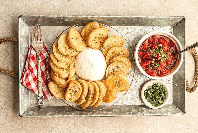 Need a quick appetizer recipe? Try this easy Burrata And Fire Roasted Tomato Bruschetta for your next party or gathering. Your guest will love this easy bruschetta recipe.