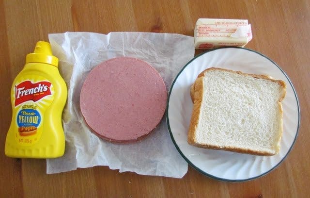 sliced bologna, mustard, soft white bread, butter