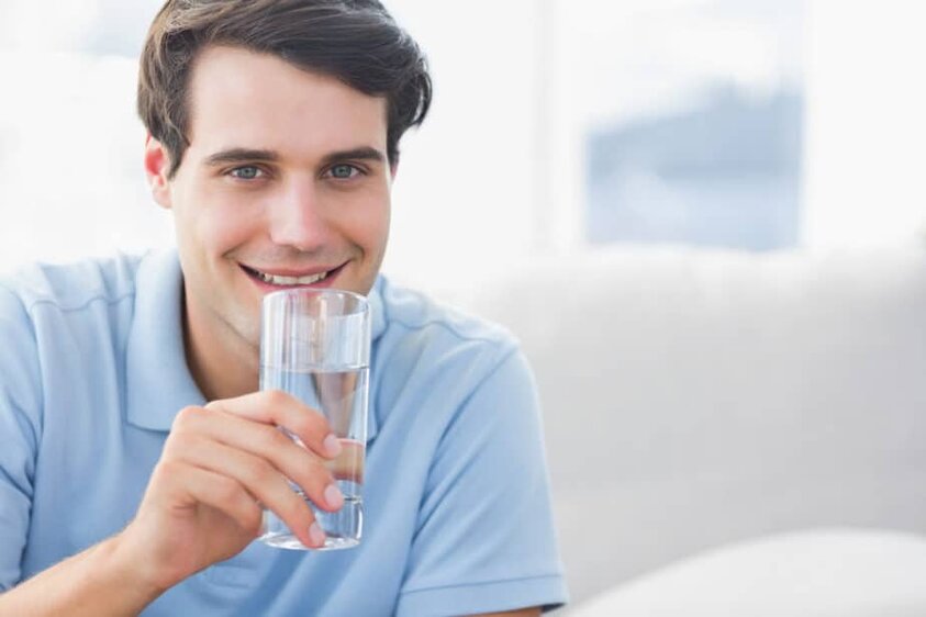 a man drinking water to beat fatigue