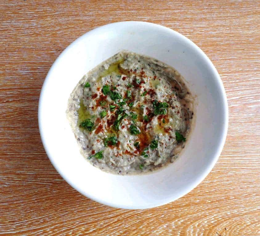 Aubergine Dip (Baba Ganoush) garnished with paprika and chopped parsley and drizzle with olive oil.