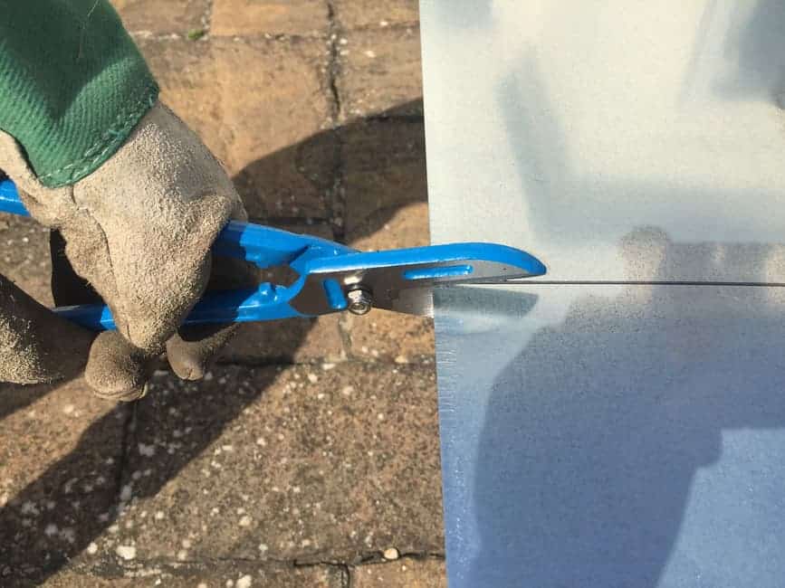 Tin snips cutting metal