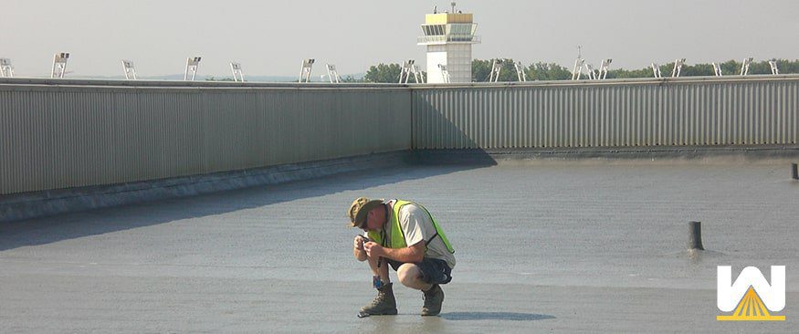 Roofing contractor inspecting a roof