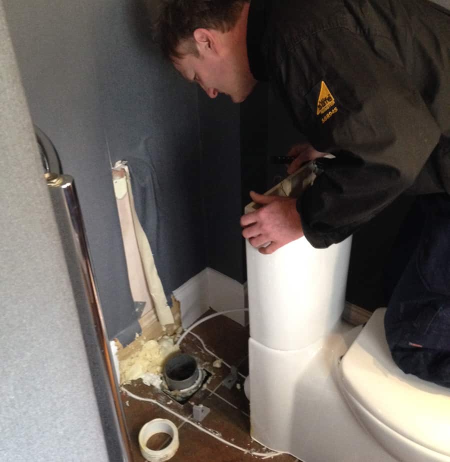one of our drainage team fixing a blocked toilet