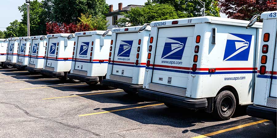 line of mail trucks...every door direct united states postal service