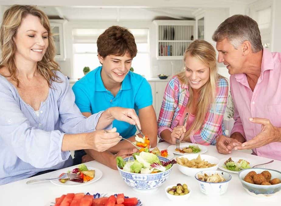 A parents and their children are eating healthy breakfast
