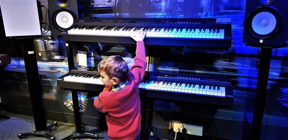 Aidan playing double keyboard at Yamaha Music London store in Soho