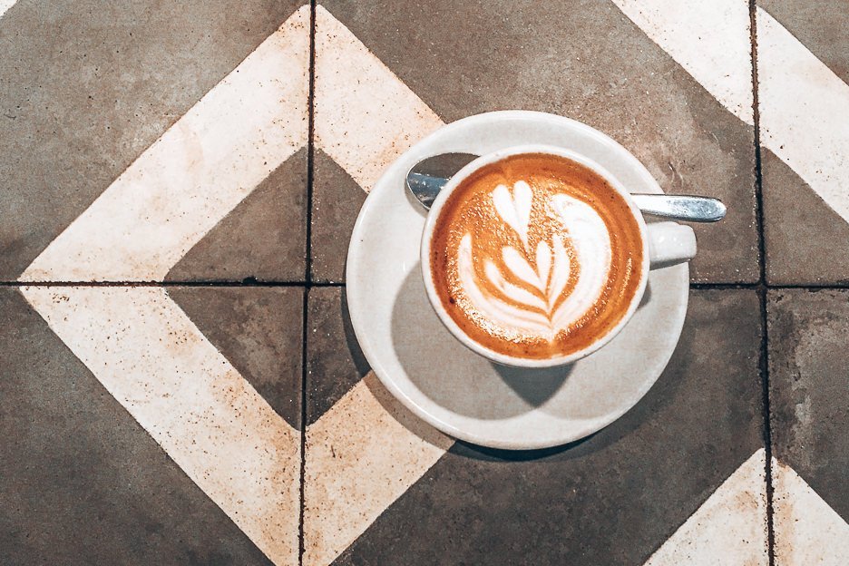 The Top 10 Cafes For Specialty Coffee In London 6 L A flat white on black and white table tiles at Association Coffee, London