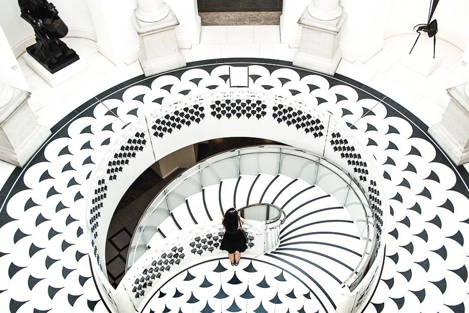 Why You Should Be An Expat At Least Once In Your Life 5 L Jasmine of The Travel Quandary stands on top of the black and white marble staircase inside the Tate Britain in London - United Kingdom