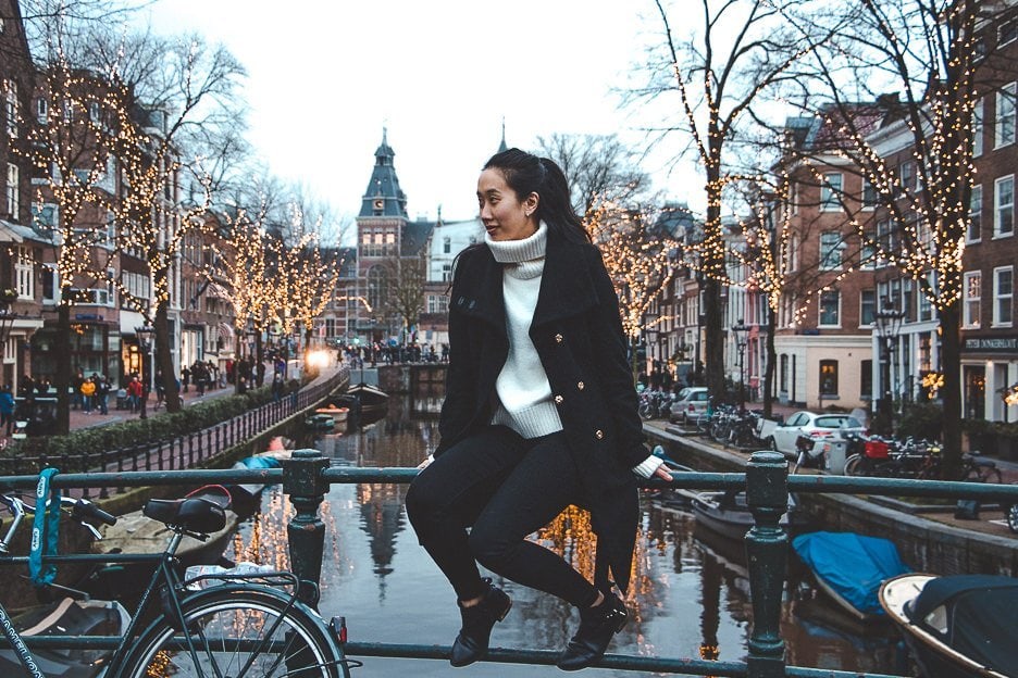 Why You Should Be An Expat At Least Once In Your Life 6 L Sitting by the canals with fairylights in the background during winter in Amsterdam, The Netherlands