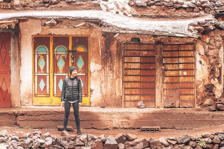 15 Important Things To Know Before You Travel To Morocco 15 L Jasmine stands in front a hut with rusted doors in the Atlas Mountains, Morocco