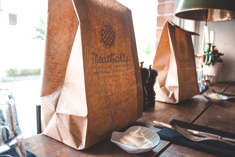 7 Easy Ways to Save Money To Travel 2 L A takeaway paper bag ready for delivery at Meatballs for the People in Stockholm, Sweden