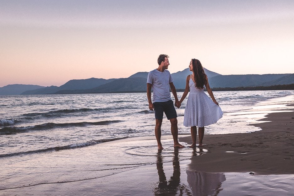 A Road Trip in Tropical North Queensland a 5 Day Campervan Itinerary from Cairns Back 15 L A couple hold hands on Four Mile Beach at sunset in Port Douglas, tropical North Queensland
