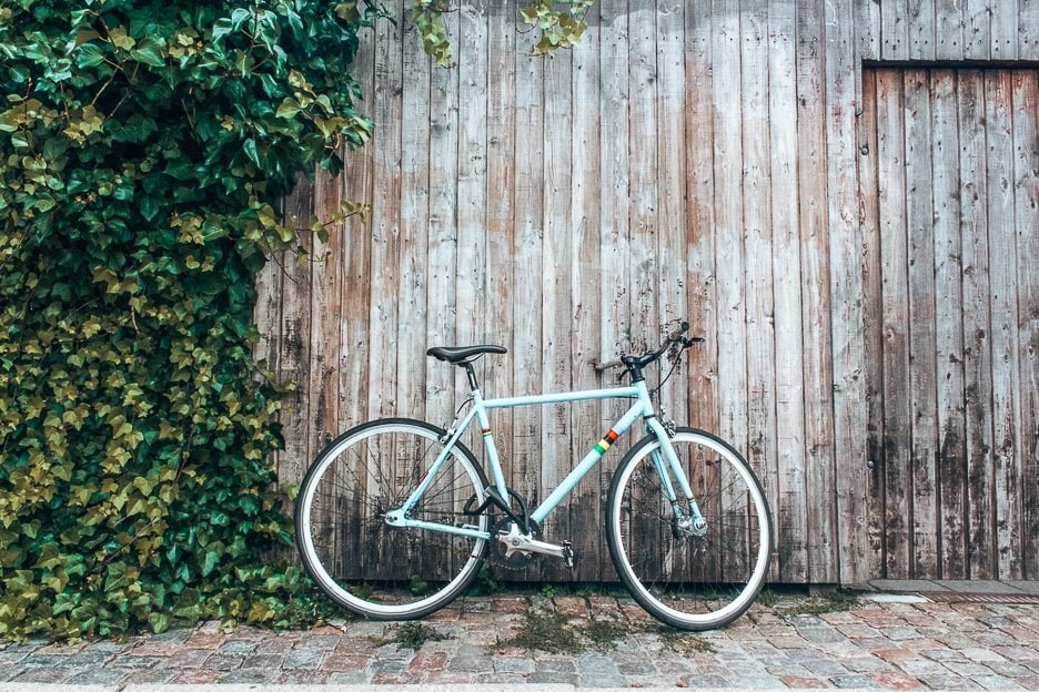 About Us 5 L A bicycle rests against a wooden wall Copenhagen