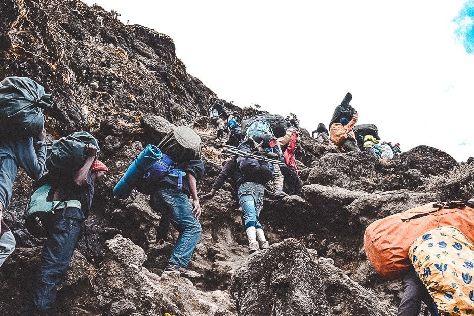 How I Summitted Kilimanjaro The Machame Route In 7 Days 14 L Porters carrying their loads up the Barranco Wall on Mt Kilimanjaro