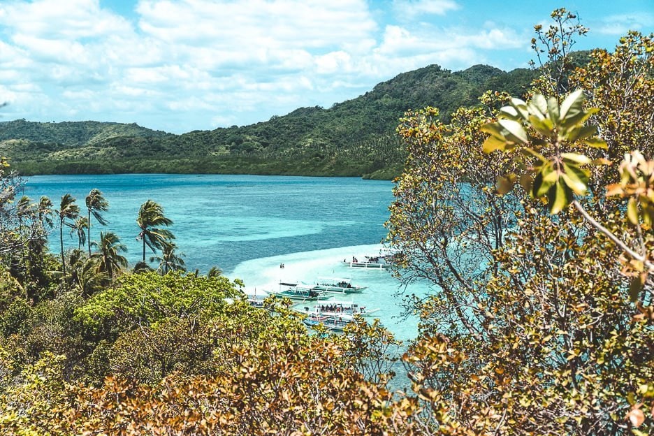 Island Hopping in the Philippines Which boat tour should I choose 3 L Boats in between the trees from the top of Snake Island, El Nido, The Philippines