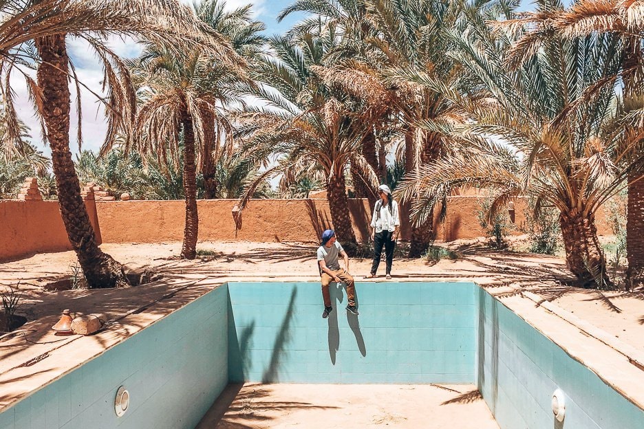 Morocco Travel Photography 35 Photos To Inspire You To Visit 7 L A man and woman on the edge of an empty pool surrounded by palm trees, Morocco