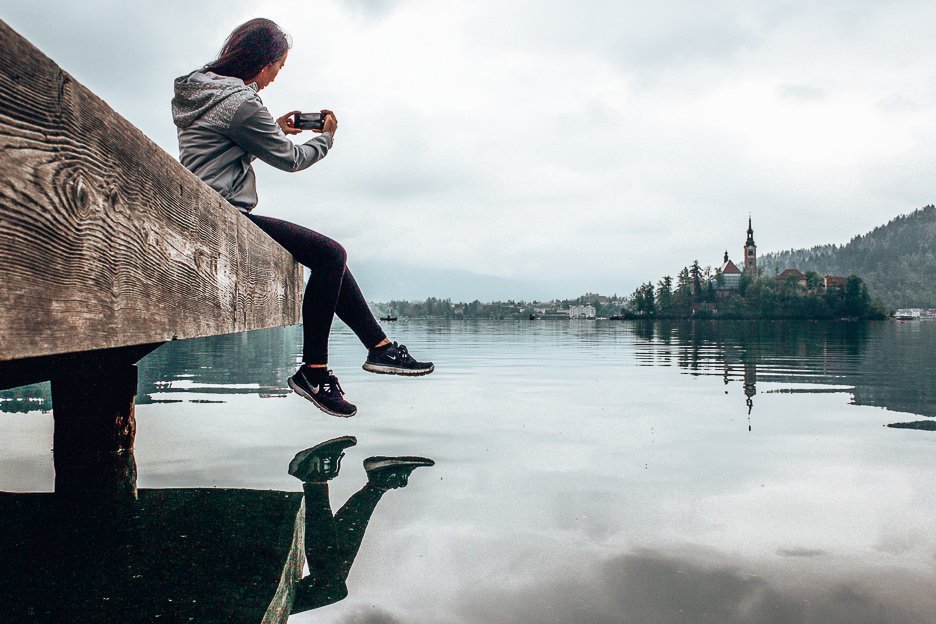 Our Favourite Photography Apps To Use On The Go 1 L Taking an iPhone photo of Bled Island, Bled Lake, Slovenia
