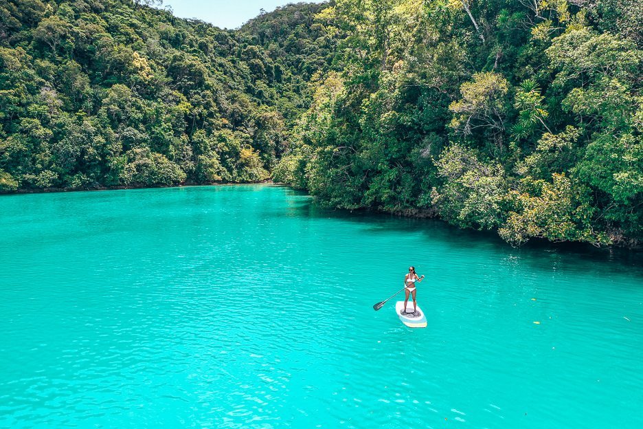 Philippines Travel Budget How Much Do I Need for 10 Days 11 L A girl stands on a SUP at Sugba Lagoon, Siargao