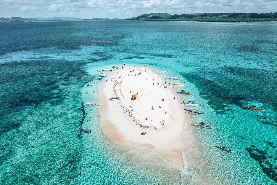 Siargao Itinerary And Aerial view of poeple and boats on Naked Island, Siargao