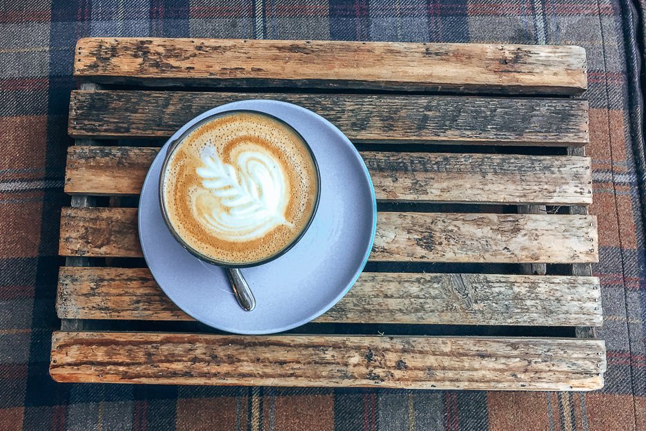 The Best 5 Specialty Coffee Shops in Edinburgh 5 L A latte served on a wooden tray at The Milkman, Coffee in Edinburgh Scotland