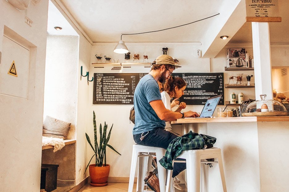The Best Coffee In Lisbon 5 Cafes Not To Miss 2 L Customers on laptops in Copenhagen Coffee Lab, Lisbon Portugal
