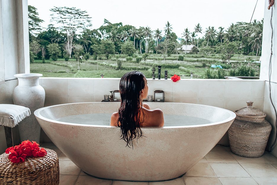 The Ultimate Gift Guide For Modern Travellers 1 L Taking a bath with a view of the rice paddies at The Shala Bali, Ubud, Indonesia