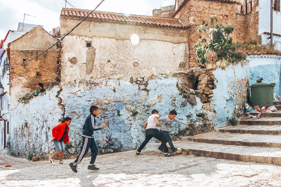 Morocco Travel Photography 35 Photos To Inspire You To Visit 29.2 L Children play football in the streets of Chefchaouen, Morocco