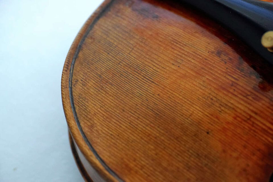 Close up of front lower right part of Guarneri model violin made in 2019