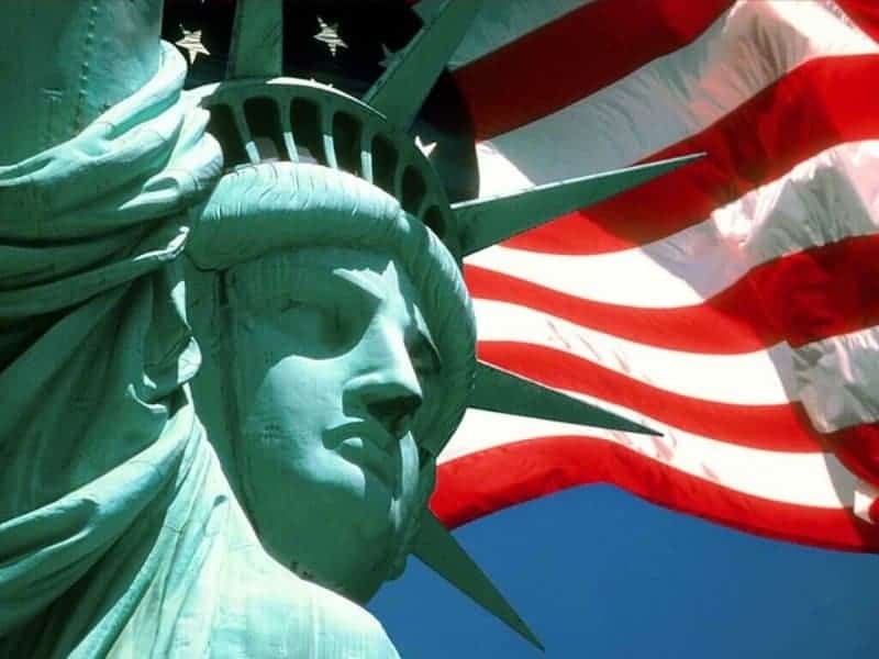 Memorial Day 2020 Memorial Day 2020 picture of the stature of liberty with US flag waving in the background