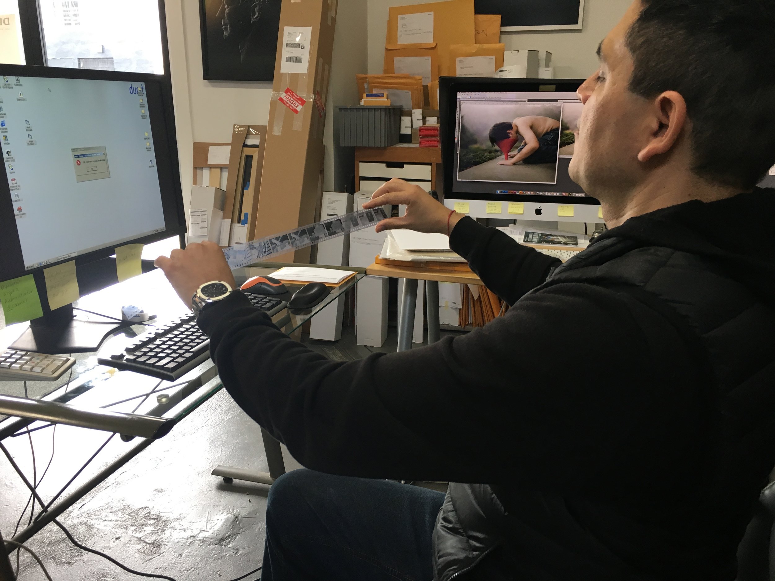 Gabriel prepares to scan a roll of film in our Durst Sigma Plus scanner.