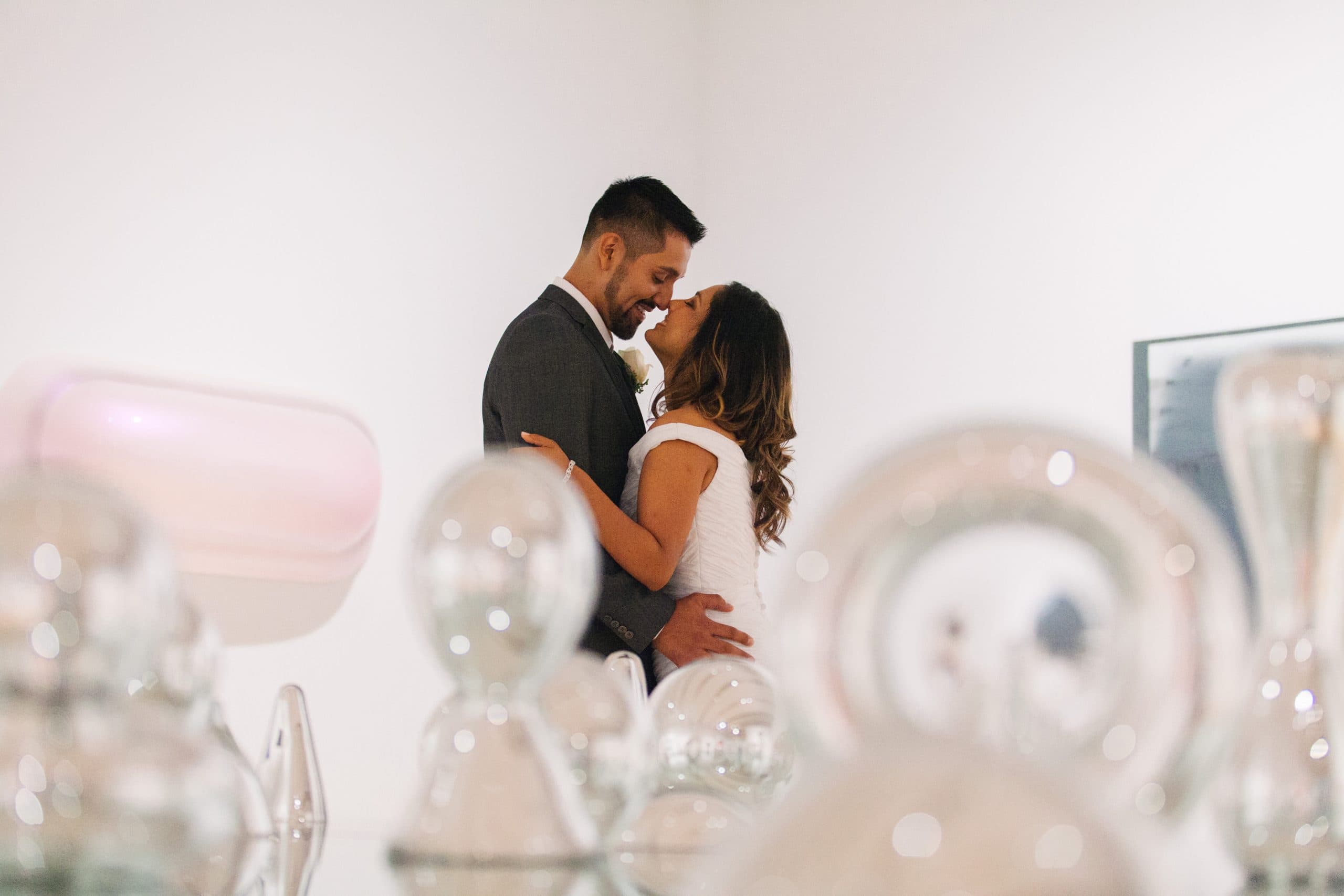 JavierAnita-76 wedding couple among glass art exhibit in Phoenix Art Museum