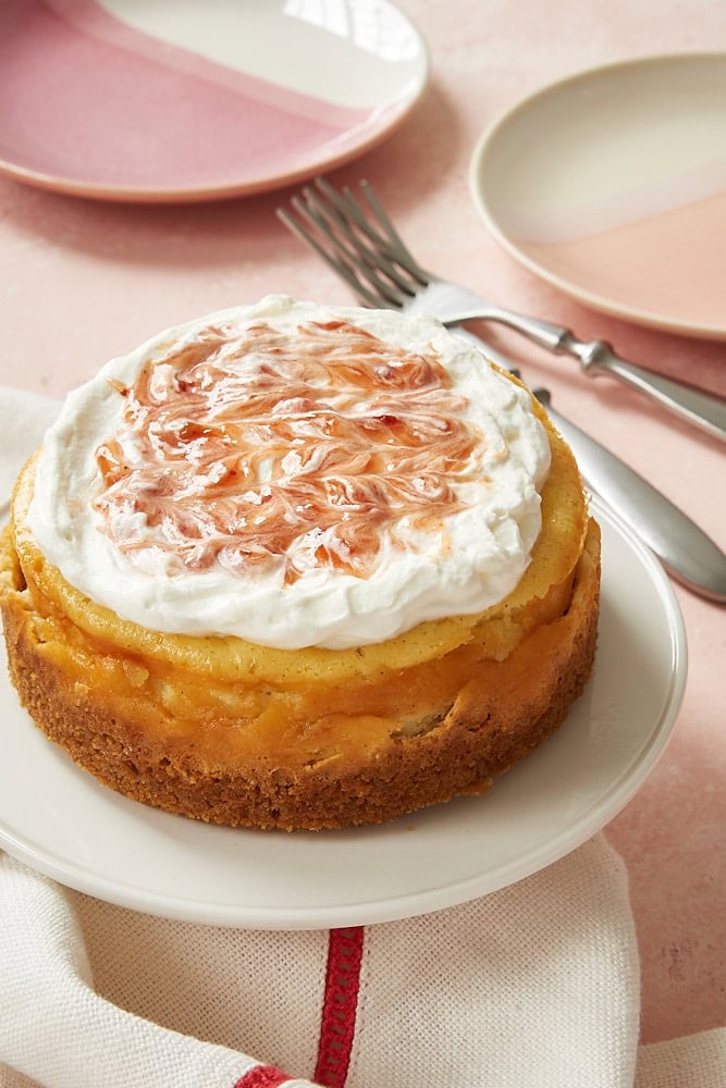 Vanilla Bean Cheesecake for Two topped with strawberry whipped cream