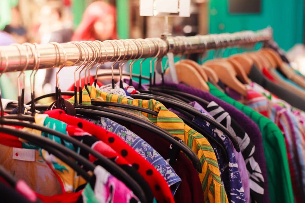 vintage clothing on a rail in a london market