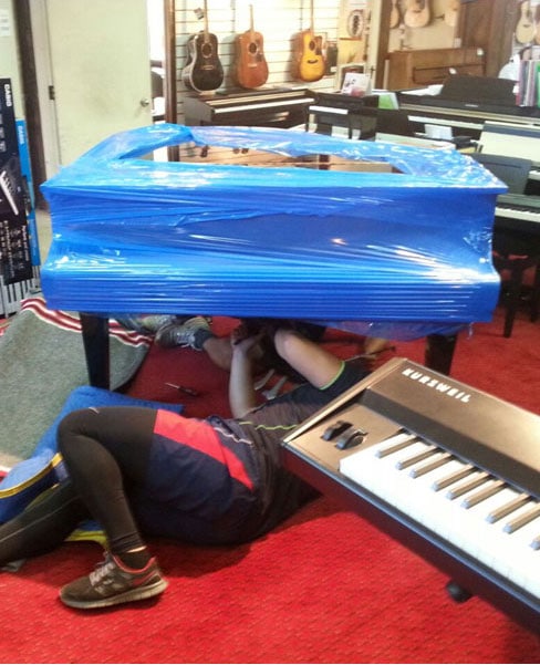 Uninstalling and wrapping the piano to move in Auckland