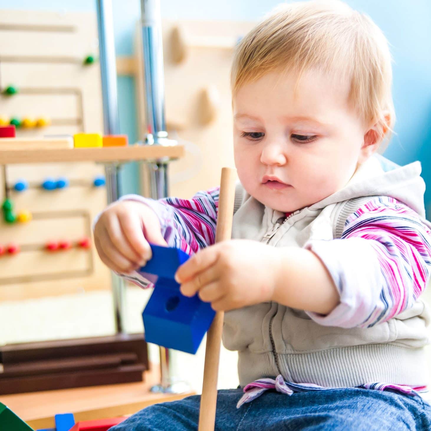 cute little girl in the classroom early development plays with n Cute little girl in the classroom early development plays with numerous toys