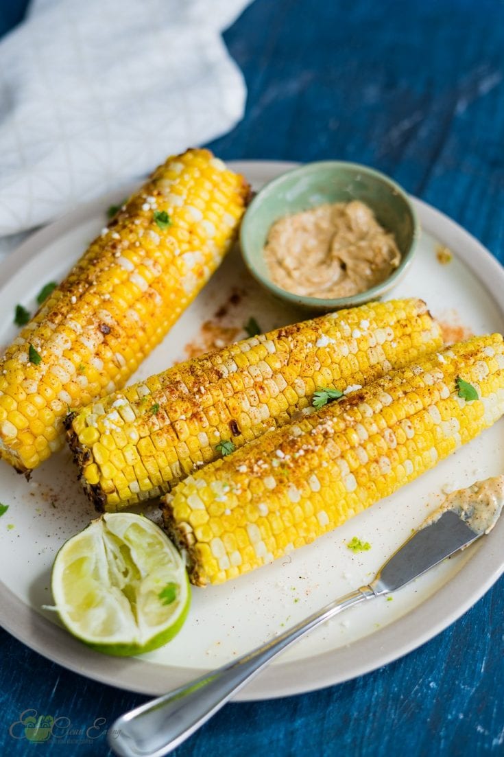 air fryer corn on the cob, serve with chili lime butter, sprinkle with paprika, goat cheese and fresh cilantro