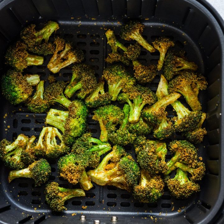 crispy air fryer broccoli inside the air fryer basket