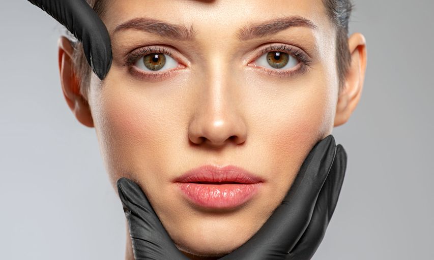 EstMed Pic - Plastic Surgeon Touching Face AdobeStock_338302071 Cropped EstMed - Plastic Surgeon Touching Face AdobeStock_338302071 Cropped