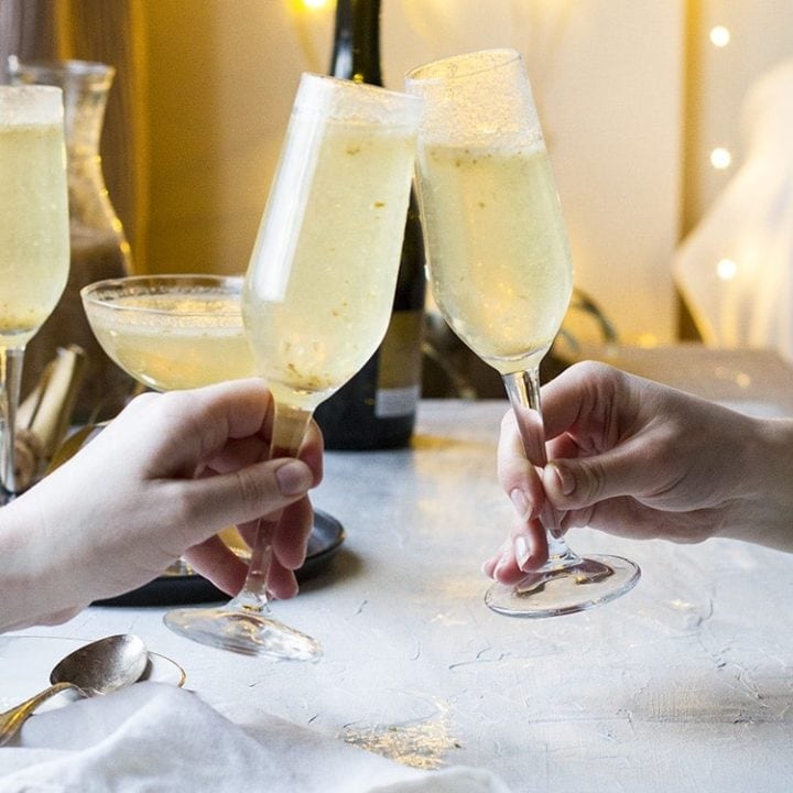 Two champagne glasses clinking.