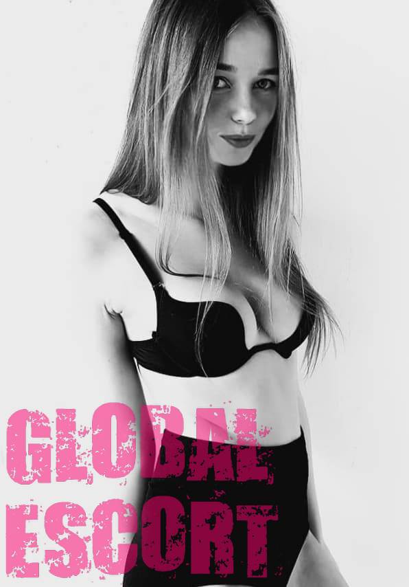 young escort model Svetlana in black lingerie posing at a photo shoot in the room