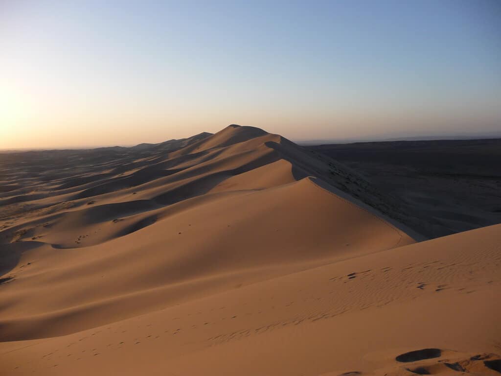 Climbing The Sand Dunes In The Gobi Desert Mongolia